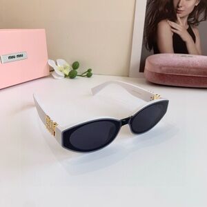 Miu Miu White Cat-Eye Sunglasses with Black Lenses and Gold Accents